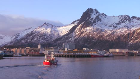 a fishing boat arrives at svolvaer the capital city of the lofoten islands norway