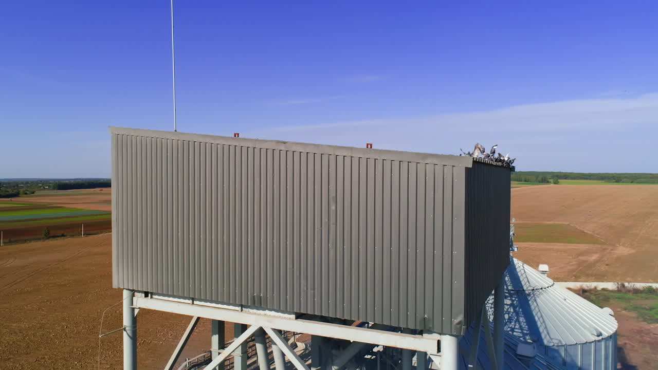 Granary grain elevators. Metal tanks for the storage crop. Large bins for farming.