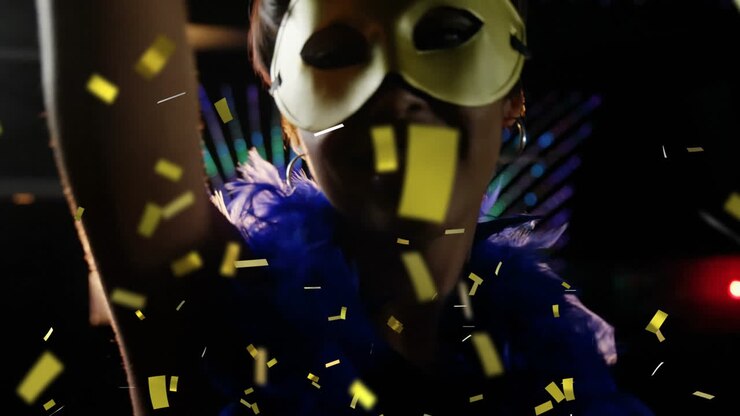 Confetti animation over person wearing mask and blue feather boa at party