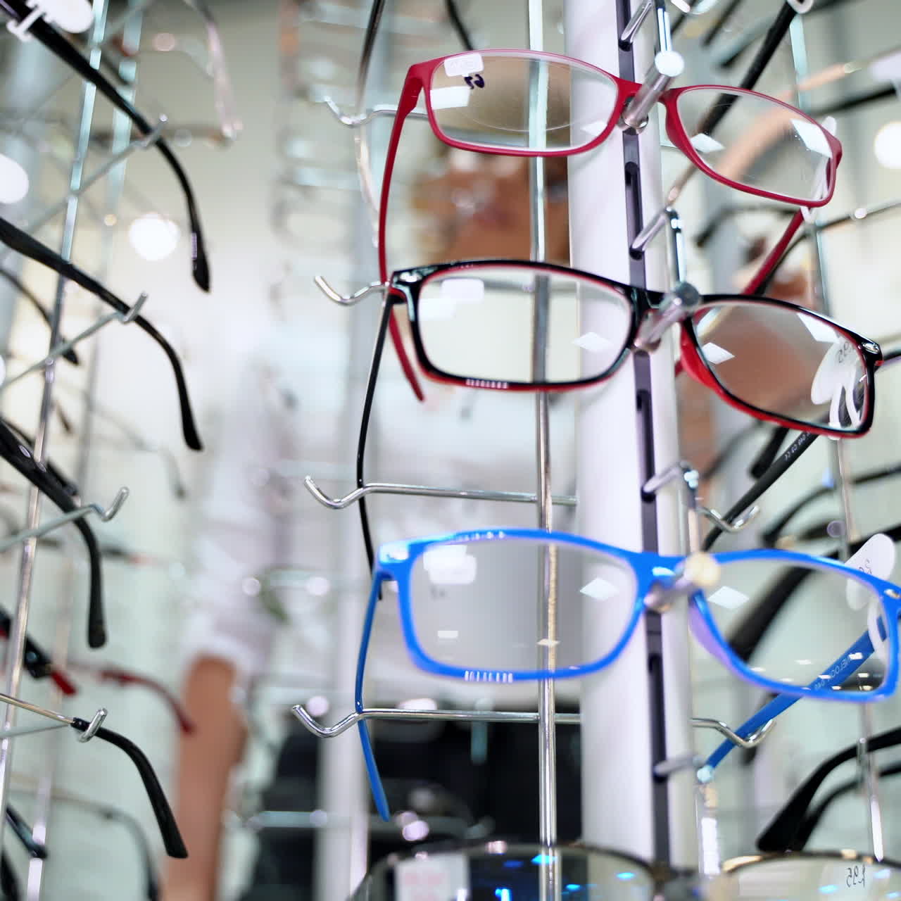 Close-up of fashionable eyeglasses in the optical shop. Spectacles of different colors and shapes nicely placed on the stand. Ophthalmology.