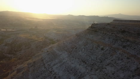 Sweeping-sunset-aerial-reveals-tourists-enjoying-eroded-valley-view