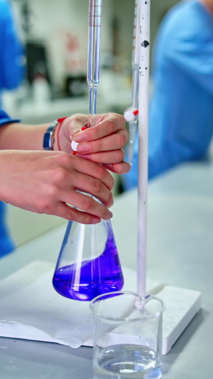 Pharmaceutical scientific female researcher in protective uniform working with dissolution tester at pharmacy industry manufacture factory laboratory. Vertical video