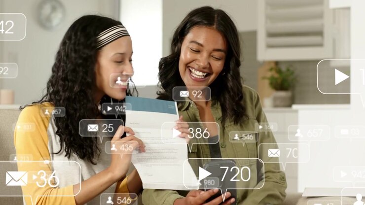Mother-daughter opening mail on sofa, checking cell while viewing social overlays to confirm buzz