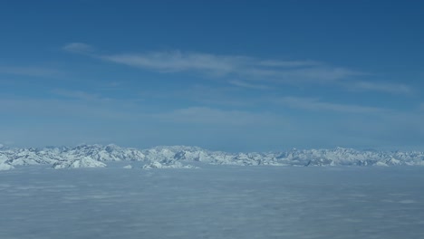 aerial view of the ne italian alps from a jet cockpit, pilot point of view, at 7000m high flying northbound near the austrian boundary