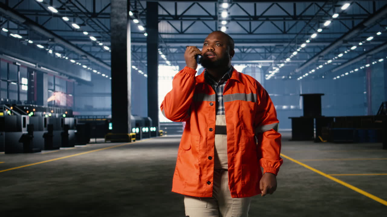 Black worker uses walkie talkie radio to guide colleague personnel