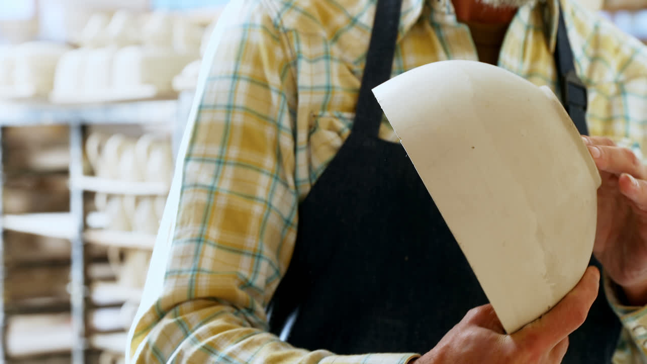 Male potter checking ceramic bowl 4k