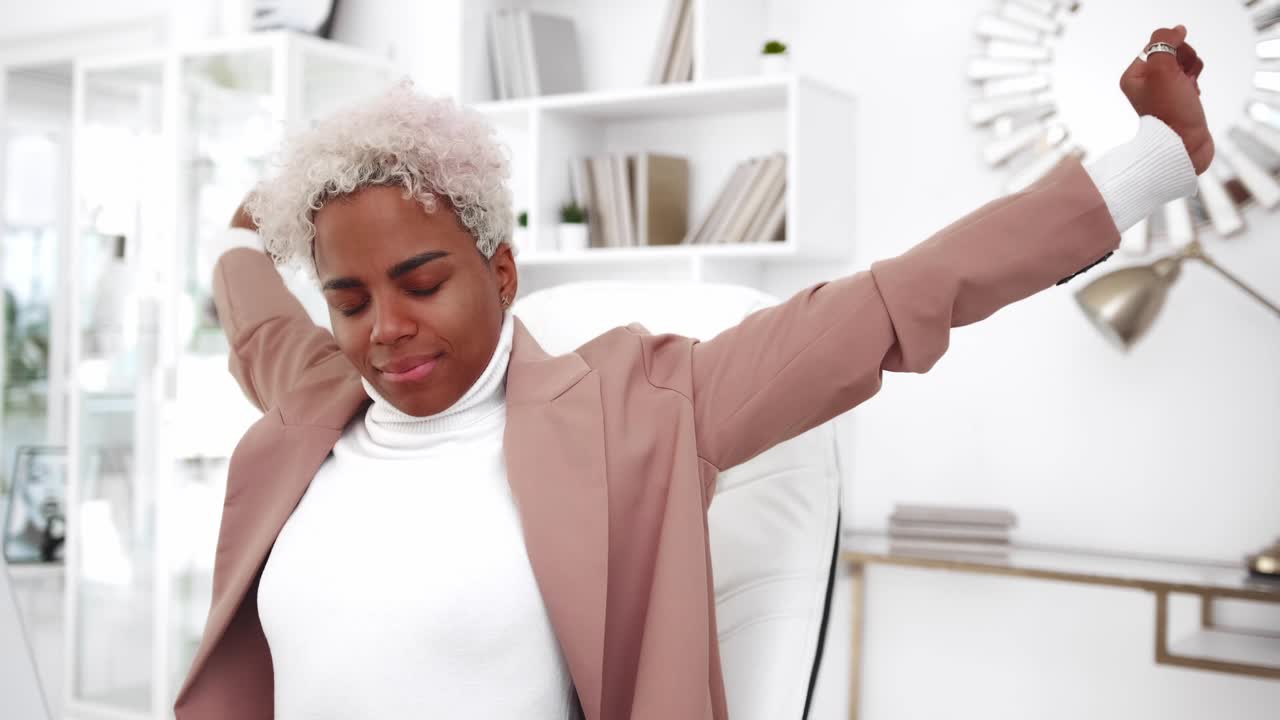 Young happy african american woman student pulling himself up in front laptop