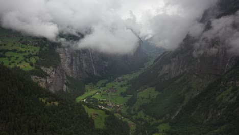 drone shot moving forward over the epic valley and village lauterbrunnen in the alps of switzerland