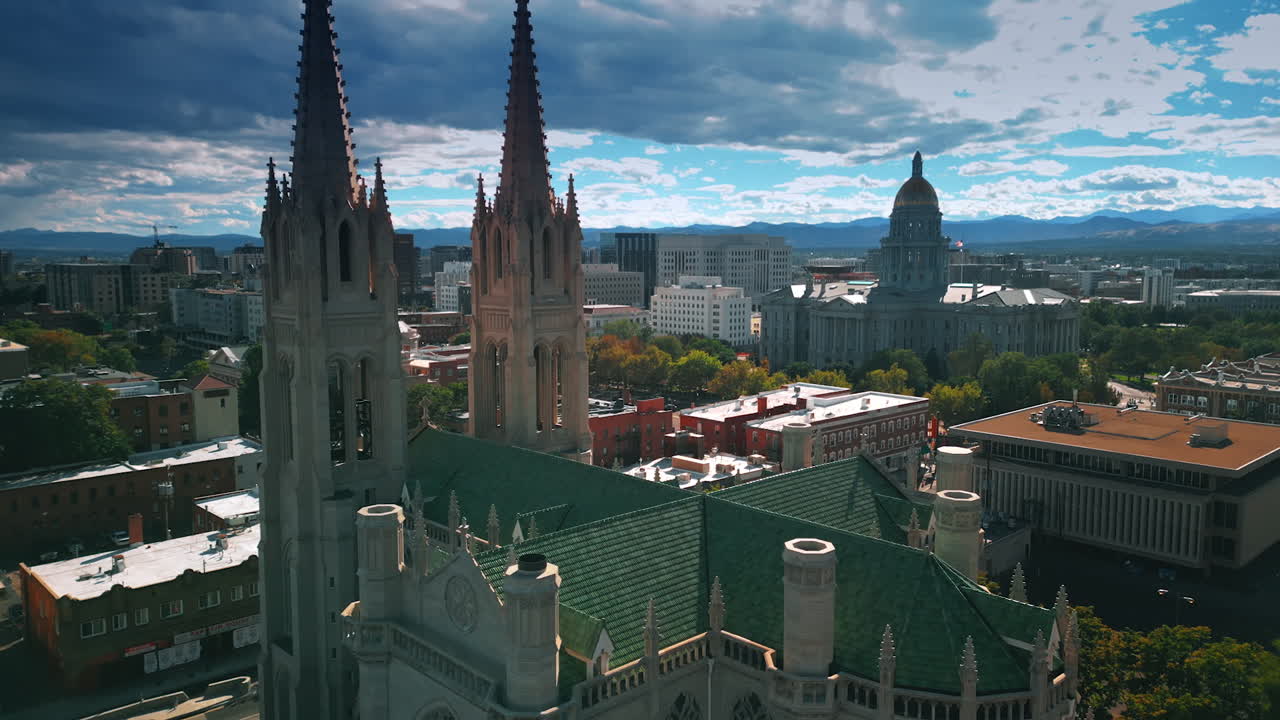 Descending at the beautiful building of the Cathedral Basilica of Denver, Colorado, USA. Cloudy sky at backdrop