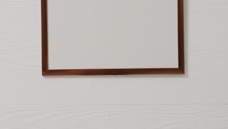 wooden frame with copy space with white background and white wall