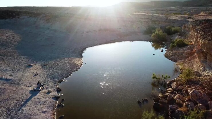 Tomada aérea ao longo de lago em cenário desértico