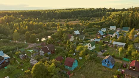 AERIAL-descending-over-the-village-on-the-sunset,-countryside,-Moscow-Region,-Russia