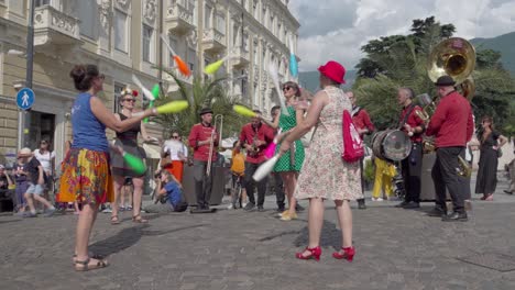 street performers: jugglers and a brass band entertain a crowd