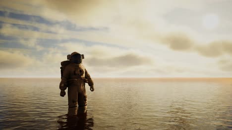 Spaceman-in-the-sea-under-clouds-at-sunset