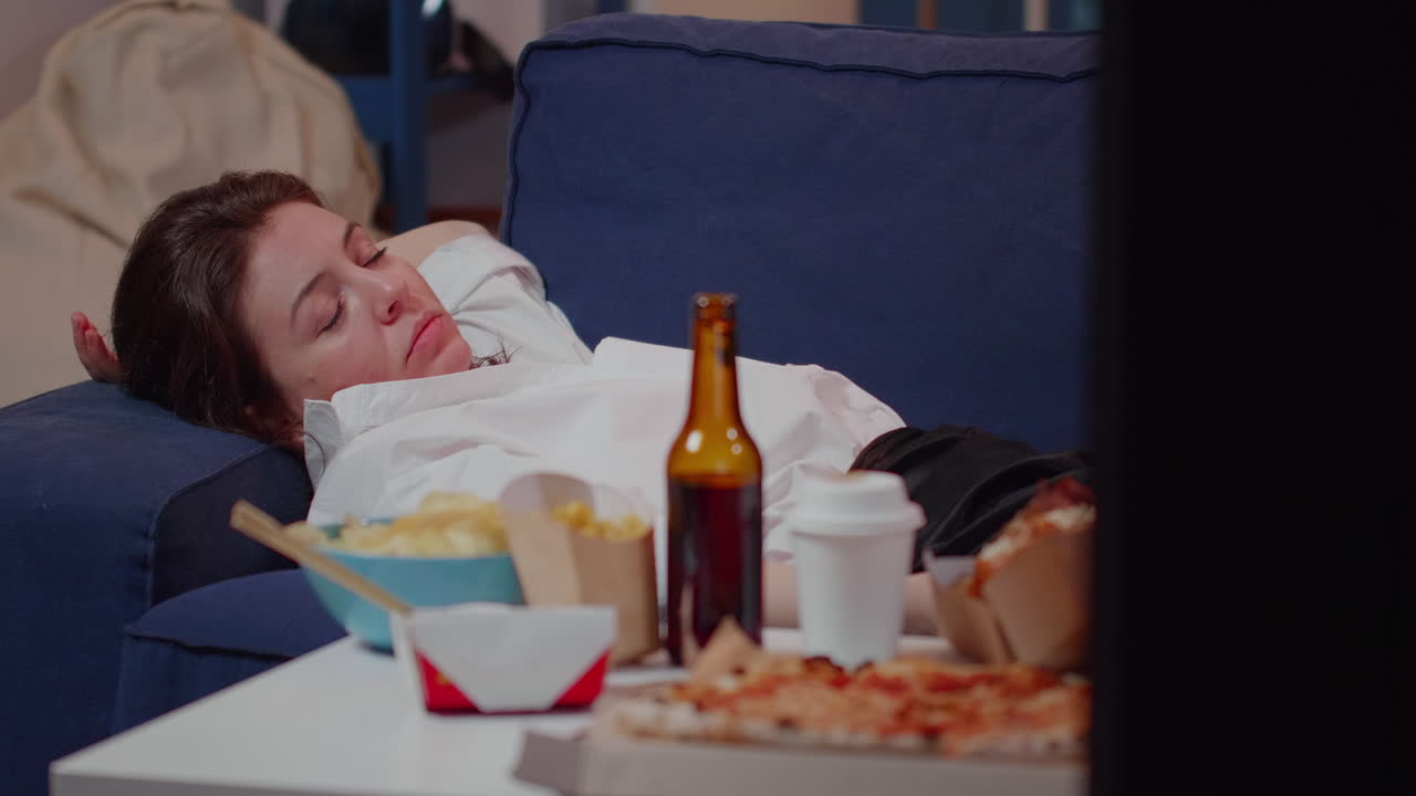 Caucasian woman falling asleep on couch at home