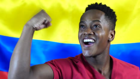 colombian young black man celebrating with colombia flag