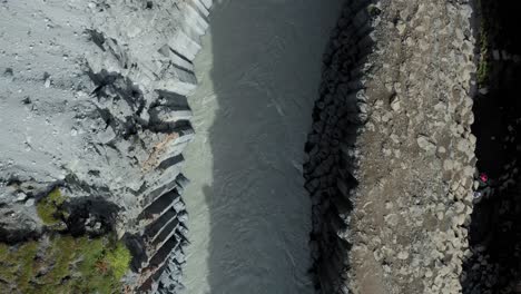 aerial top down over stuðlagil canyon with iconic basalt rock columns, iceland