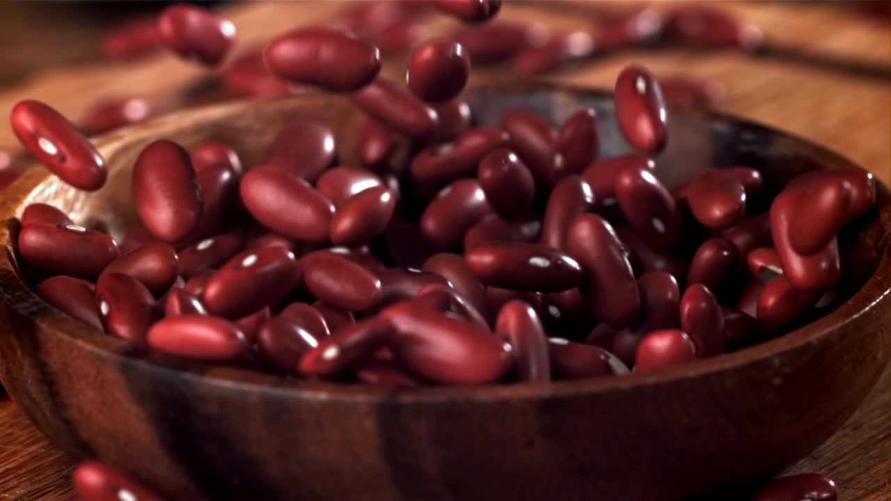 Red Kidney Beans Falling into a Wooden Bowl in Slow Motion