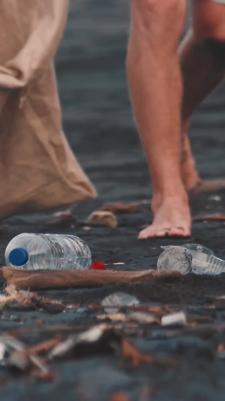 Volunteer removes garbage from ground demonstrating desire to save planet