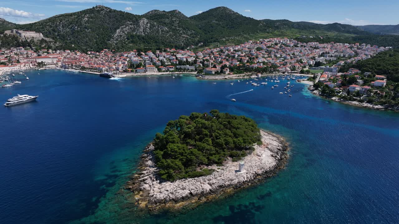 Scenic aerial shot of Hvar Town, Jerolim and Pakleni Islands with boats on the Adriatic Sea