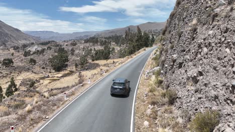 aerial dolly drone shot of a moving car