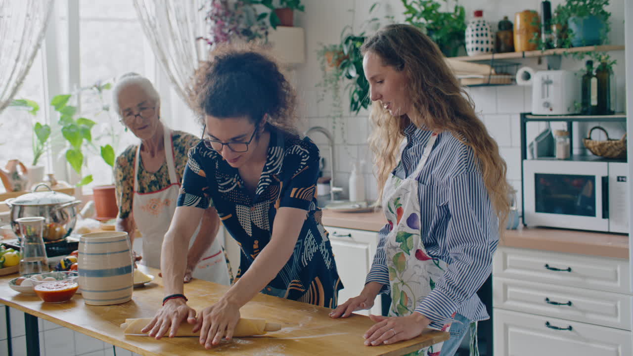Boy Learning Dough Rolling Together with Sister and Grandmother in Home Kitchen