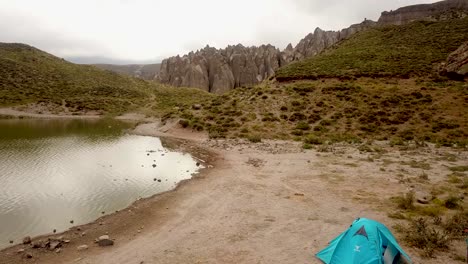 Camping-by-the-small-lake-near-the-beautiful-pillar-rocks-in-the-valley-of-Sabalan-mountains-in-a-cloudy-day-time-in-Iran