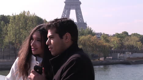 two people next to the eiffel tower