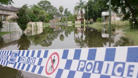 suburban street taped off by police due to flooding