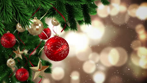 video composition with falling snow over  pine with red bubbles hanging