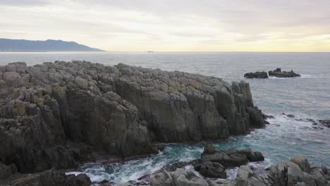 tojinbo cliffs and waves from the sea of japan at sunset