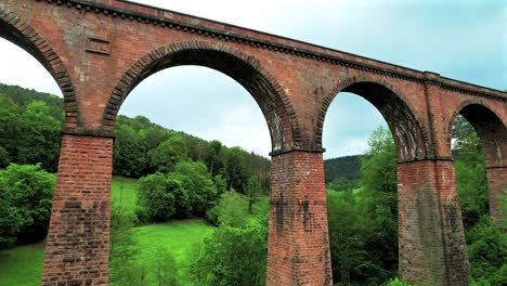 aerial view, flight to stone arch bridge himbächel viaduct, erbach, germany