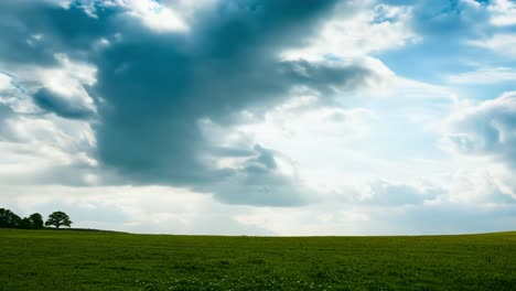 stunning view of a green field under a blue sky with clouds