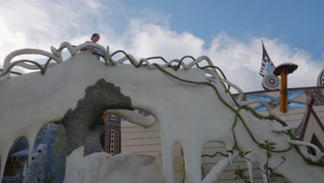 Female-Tourist-On-Bizarre-Structures-At-Hang-Nga-Villa-In-Da-Lat,-Vietnam