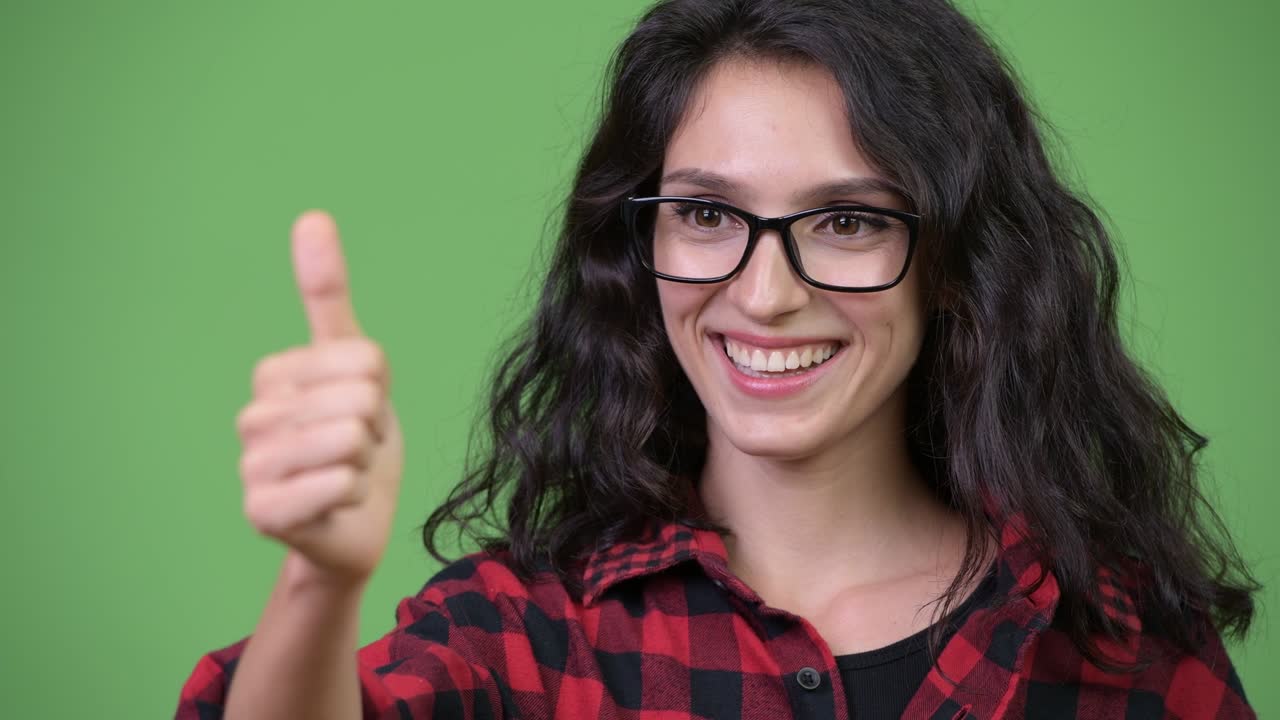 Young beautiful businesswoman giving thumbs up