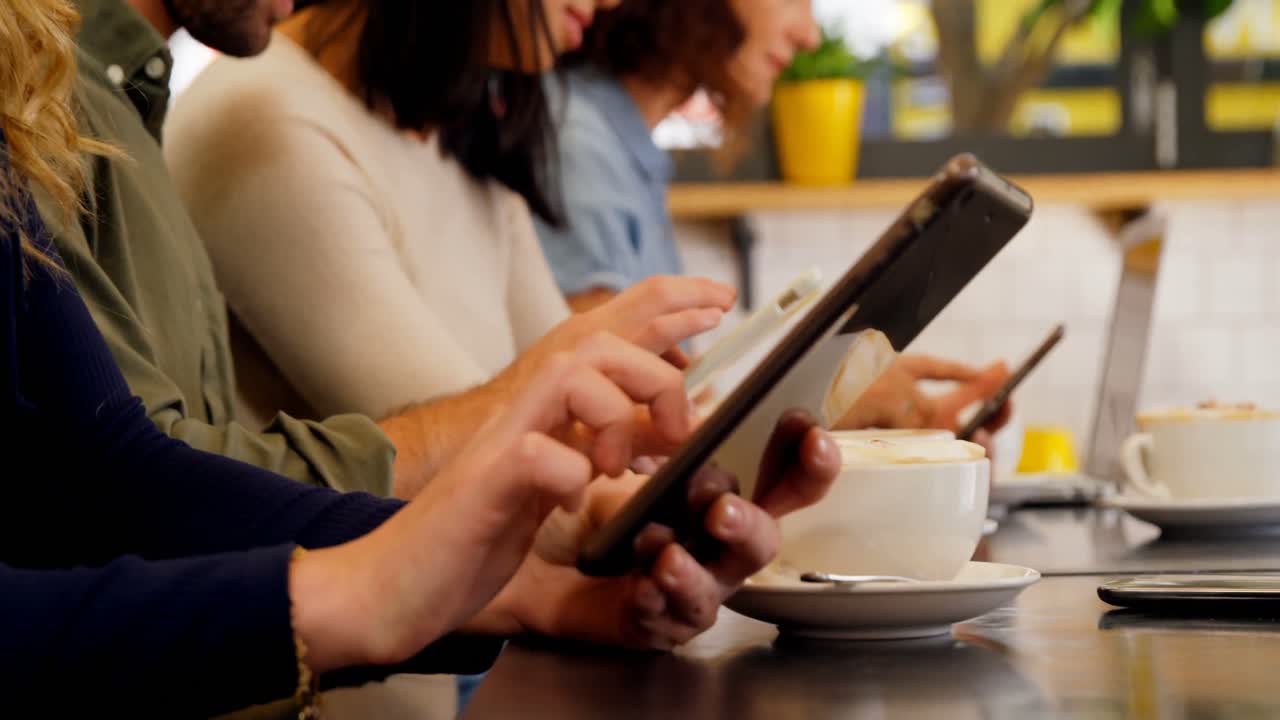 Mid section of executives using digital tablet at table 4k
