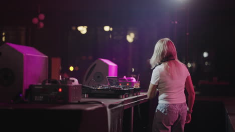 female dj performing at a nightclub