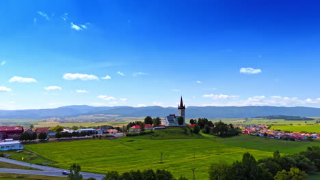 picturesque valley surrounded by the mountain range. approaching the old church located on the hill. slovakia.