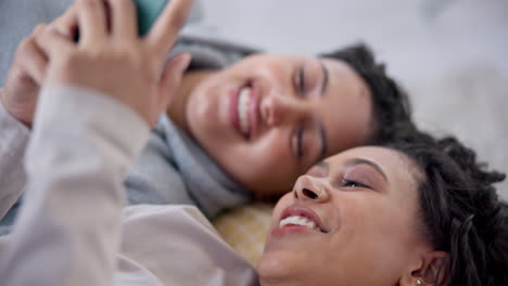 Phone,-relax-and-happy-lesbian-couple-reading