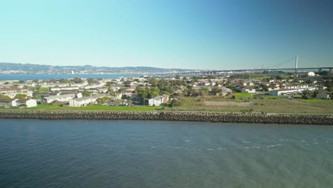 Pan drone shot of Treasure Island in the day with San Francisco-Oakland Bay Bridge, USA