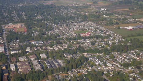 Passenger-View-Overflying-an-Urban-Area-on-a-Sunny-Day