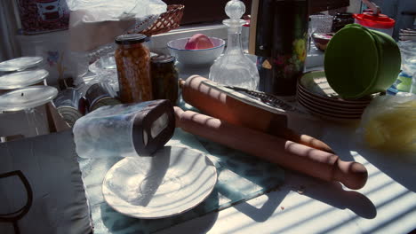 Plate,-glasses-and-cooking-utensils-placed-out-of-order-on-the-kitchen-counter