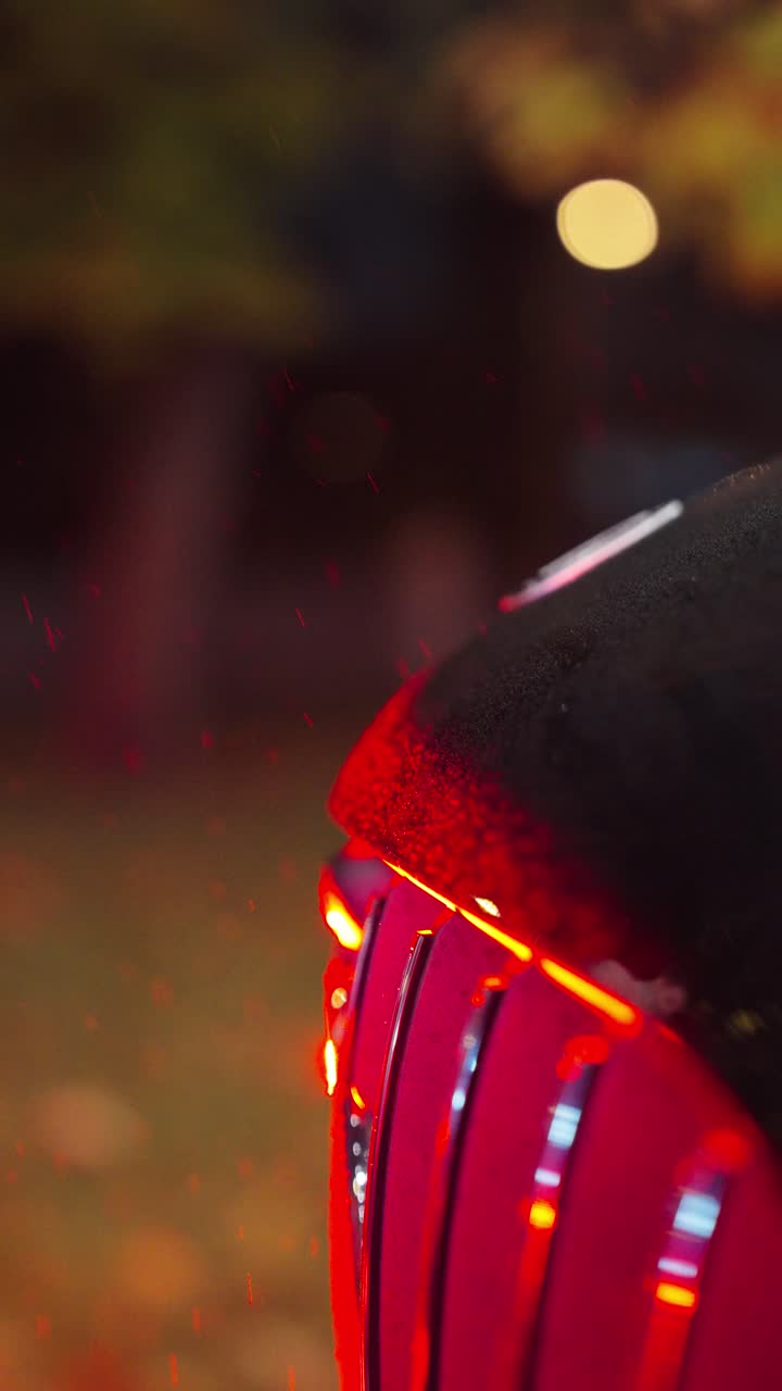 Vertical close up of front grill of car with red hue color illumination, Czechia