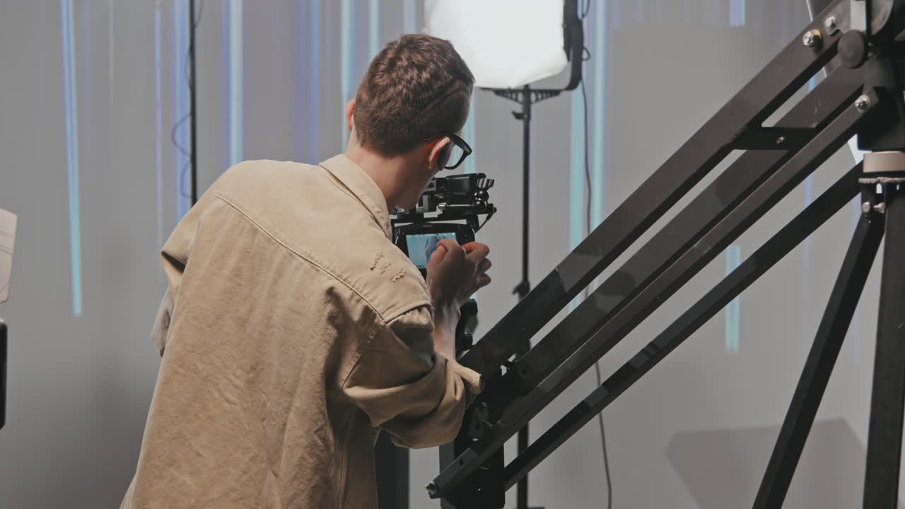 Professional Video Operator Setting Up Camera Before Shooting