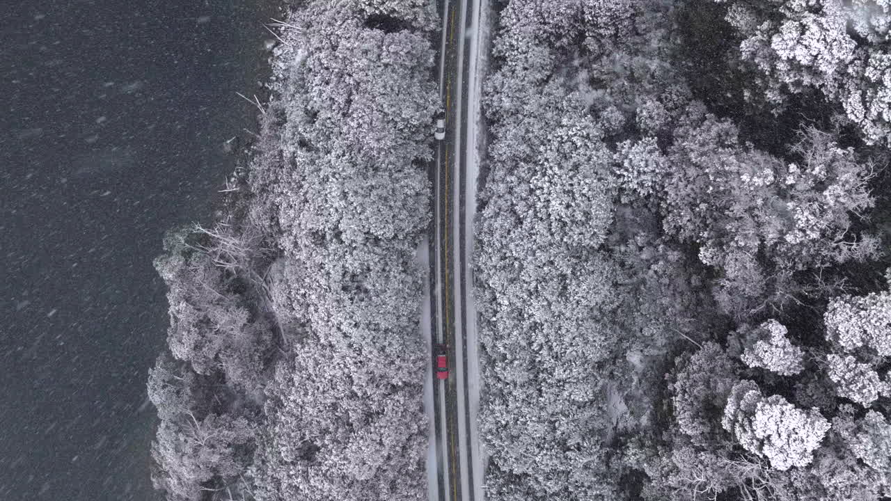 Top-down drone shot of Route 40 in winter landscape near Bariloche Argentina, travel freedom and scenic exploration