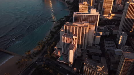 aerial shot at sunrise showing honolulu city and waikiki beach in oahu, hawaii