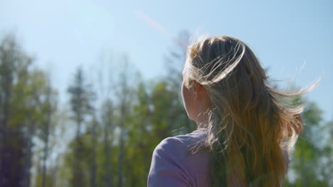 woman in nature looking up