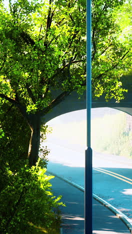 a path under a bridge with a tree on the side