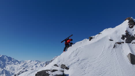 a professional skier hikes up a steep ridge in verbier, then drops into an epic freeride descent. pure adventure skiing in deep snow, dramatic terrain, and breathtaking alpine scenery.