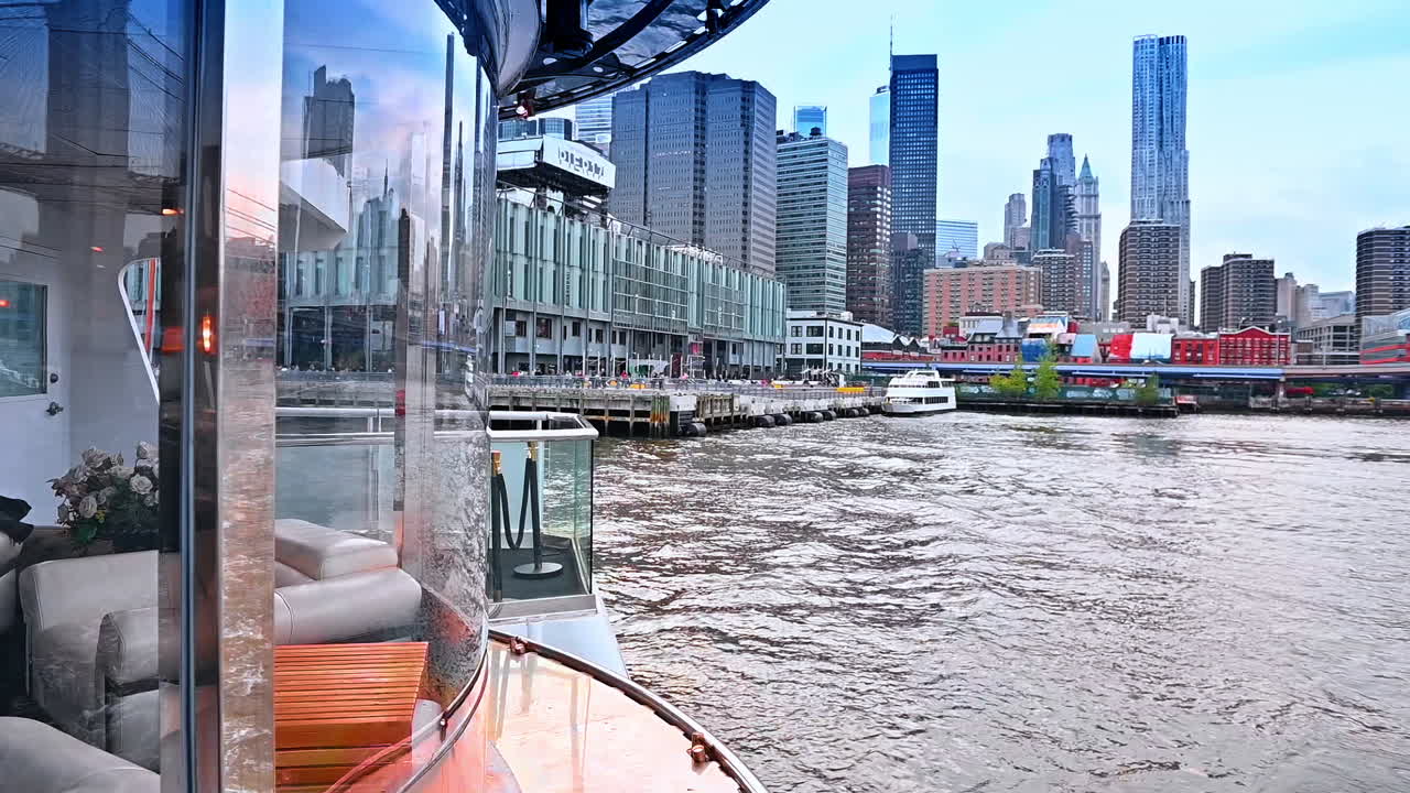 Footage from the modern boat moving by the river. Stunning buildings of New York at the waterfront